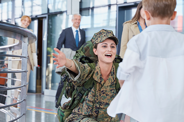 soldier is going to hug her child with smile